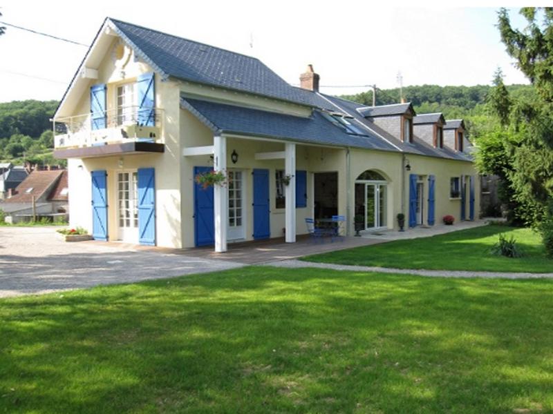 a house with blue doors and a yard at Chambre d'hôtes La Chatelière in Prémery