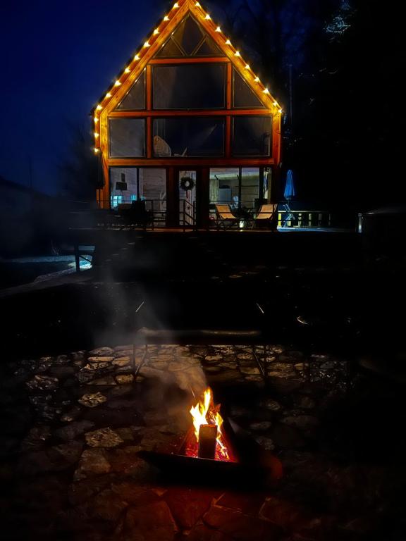 a fire in front of a house at night at Tysha House in Ternopil