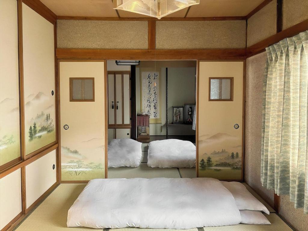 a bedroom with a bed and a large mirror at Hi Song Villa in Otaru