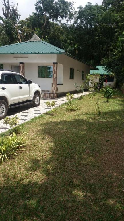 a white car parked in front of a house at Skyfall Villa in Chillithodu