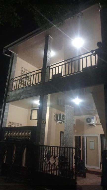 a house with a balcony with a light on it at Arsya kost homestay in Balikpapan