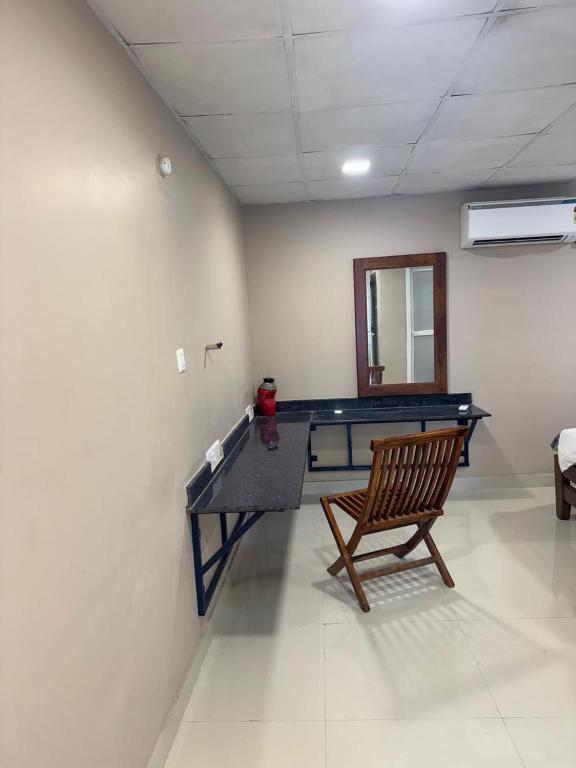 a room with a ping pong table and a chair at Jp Resorts in Muttupet