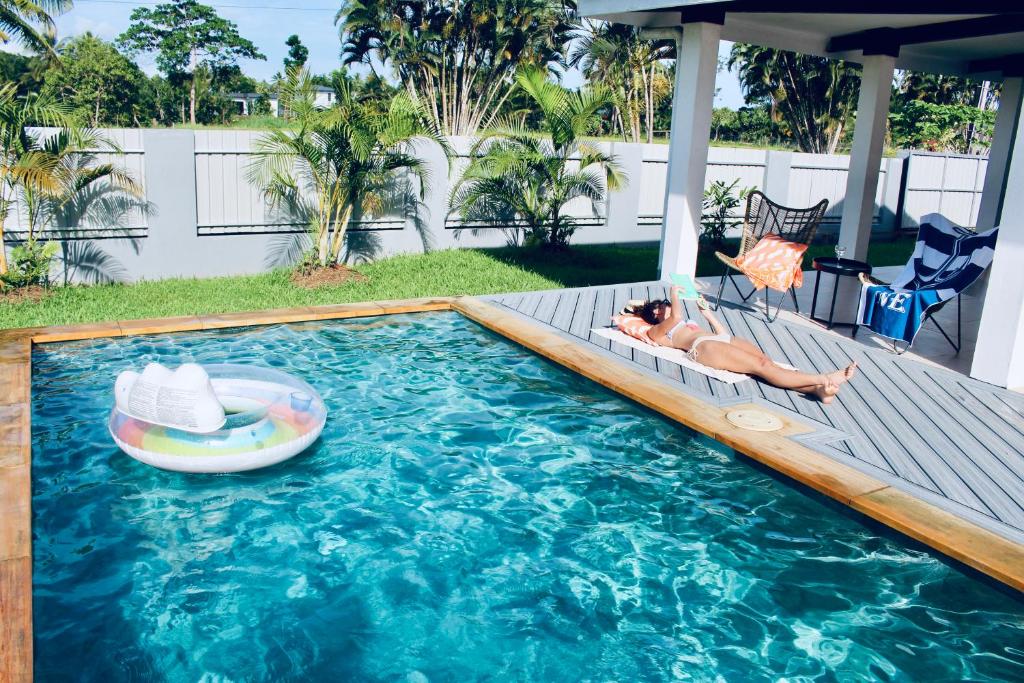 a baby laying on a raft in a swimming pool at Villa Ahava in Pacific Harbour