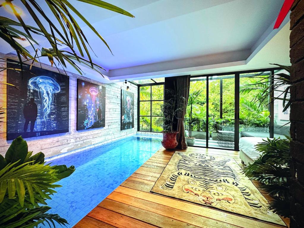 a house with a swimming pool in a room with windows at Z Loft Seaside FutureJungle Loft in Nathon Bay