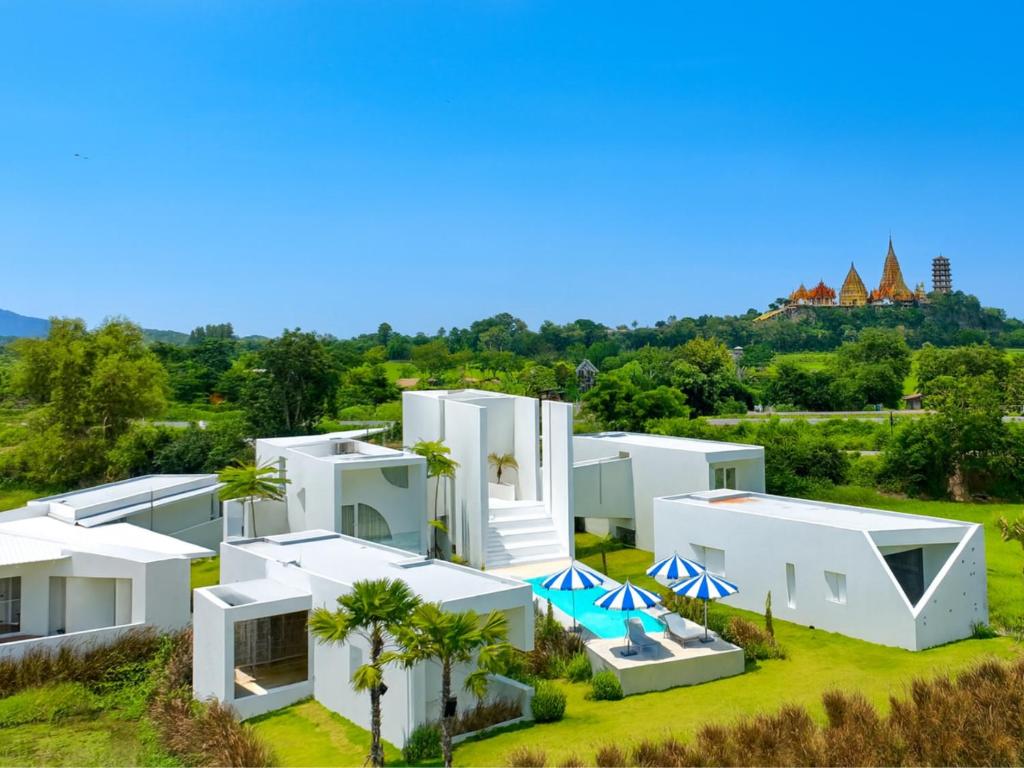an aerial view of a white house with palm trees at MITI TIKAAN villa in Ban Muang Chum