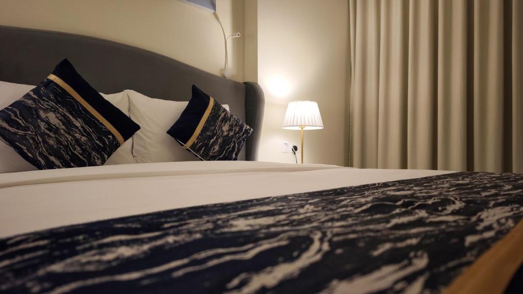 a bedroom with a large bed with pillows at فندق براي Brai Hotel in Ad Dawādimī