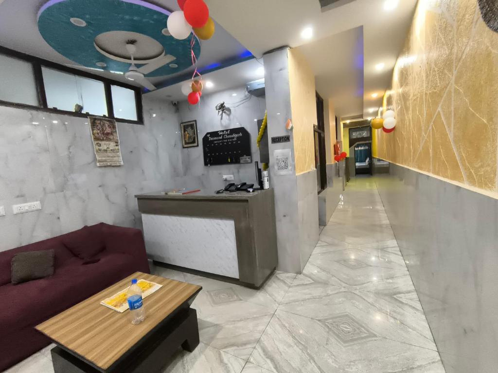 a room with a bar and a couch and a table at Hotel the diamond Ring in Chandīgarh