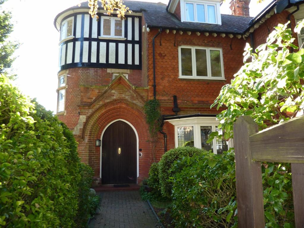 a brick house with a black and white turret at The Manse B&B in Eastbourne