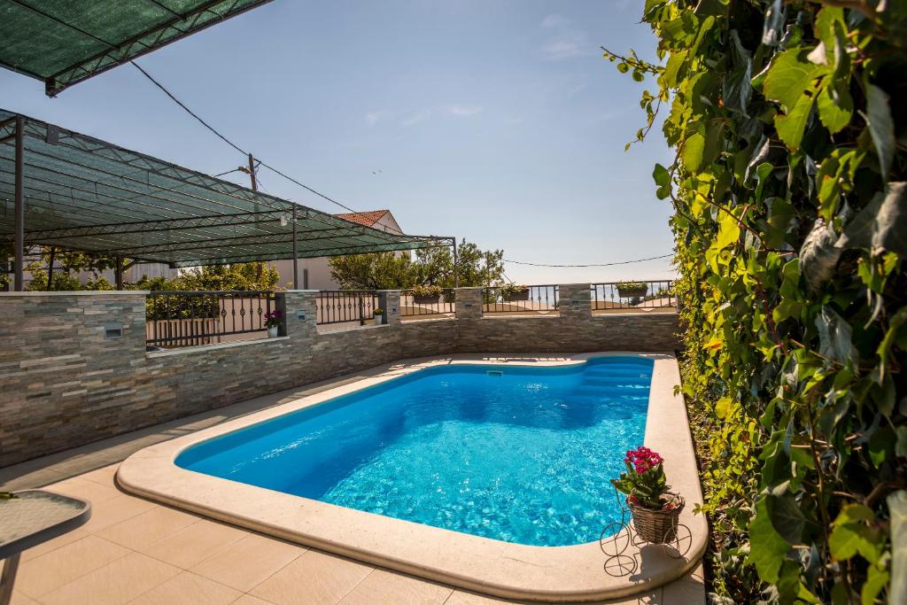 a swimming pool in the backyard of a house at Holiday Home Petra in Podstrana