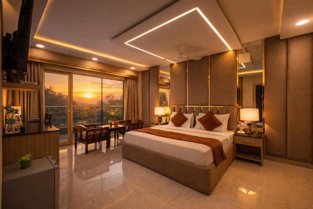 a hotel room with a bed and a dining room at Hotel Downtown by Quadis - East of Kailash in New Delhi