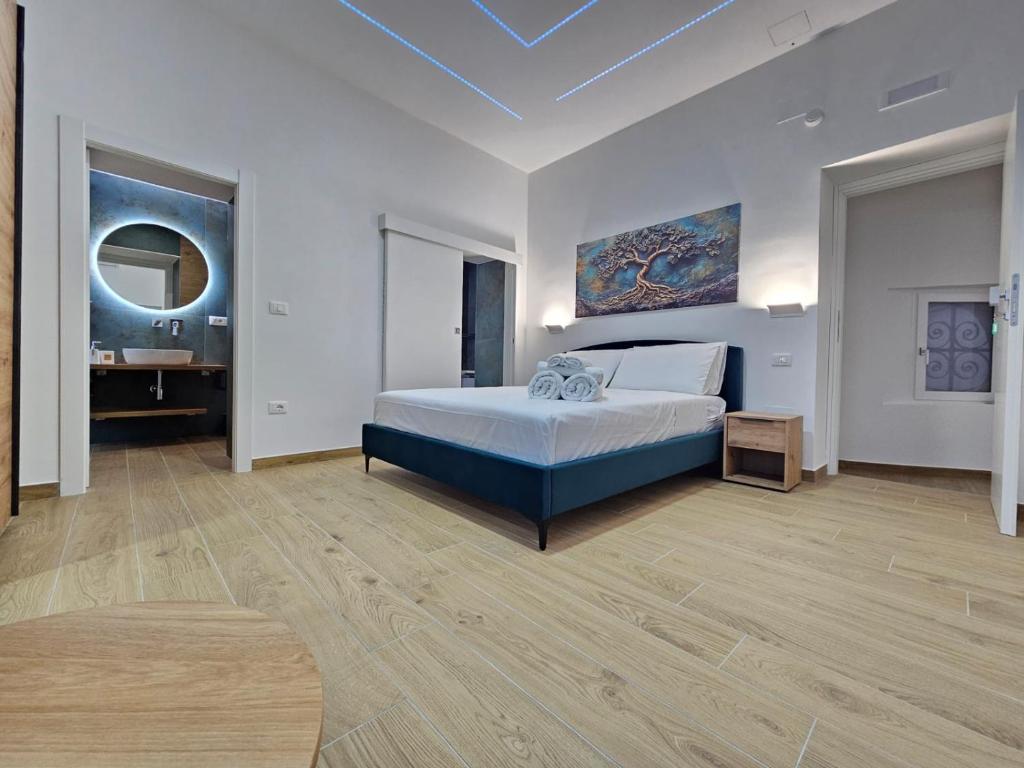 a bedroom with a bed and a table in it at Olimpo Caserta in Caserta