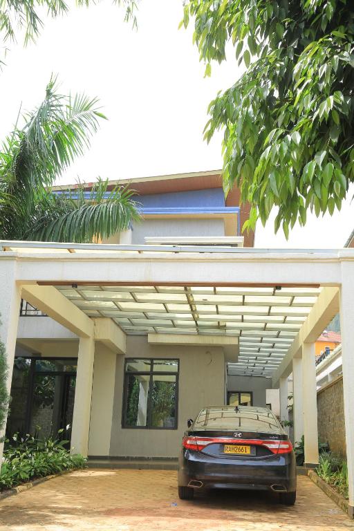a car parked in front of a garage at KIGALI QUEENs HOME AND APARTMENT in Kigali