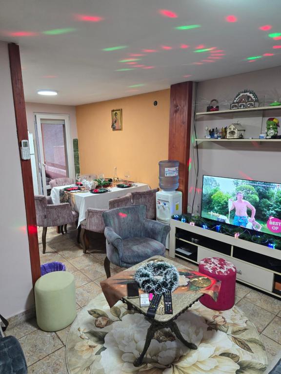 a living room with a flat screen tv and a table at Premecki konak in Čačak