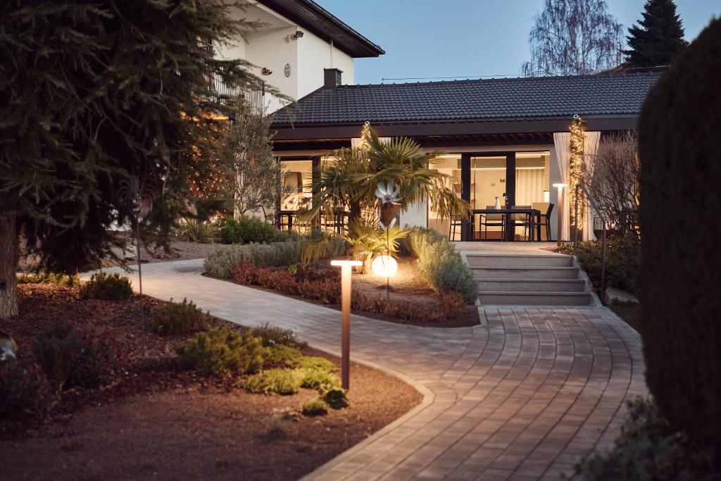 a house with a walkway in front of a house at Villa Sawian in Appiano sulla Strada del Vino