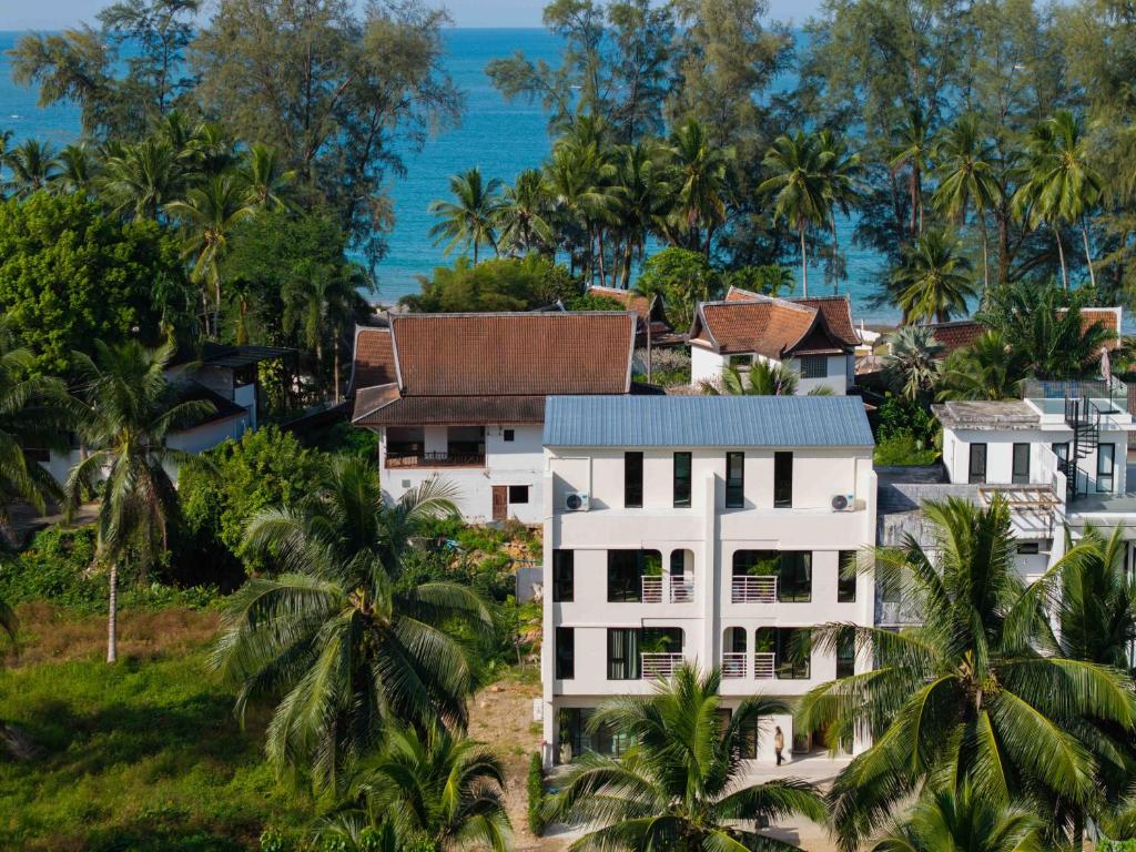 an aerial view of a resort with palm trees and the ocean at ELYSIUM Villa Khao Lak in Khao Lak
