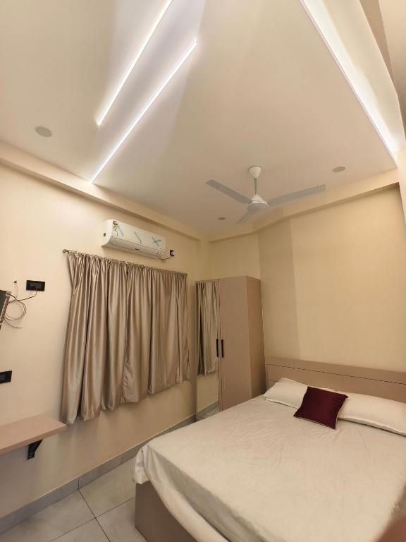 a bedroom with a bed and a ceiling fan at C K Residency in Cochin