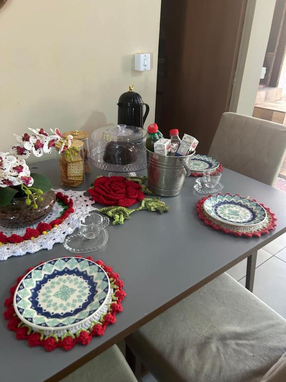 a table with plates and dishes on it at Refúgio Dom Emanuel in Pirenópolis