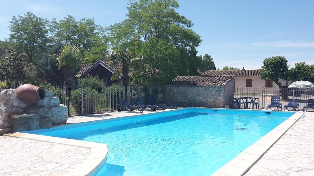 a swimming pool in front of a house at Mirabel #2, Maisonette, terrace and pool access in Grospierres
