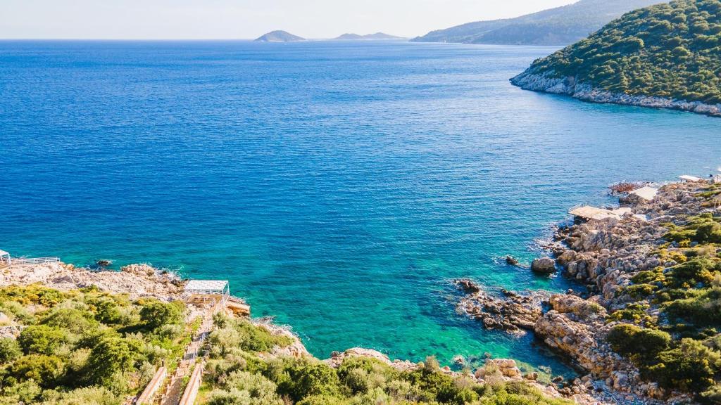 an aerial view of the ocean near a rocky coast at BEACHFRONT WHITE VILLA WİTH PRIVATE SWIMMING POOL in Kalkan