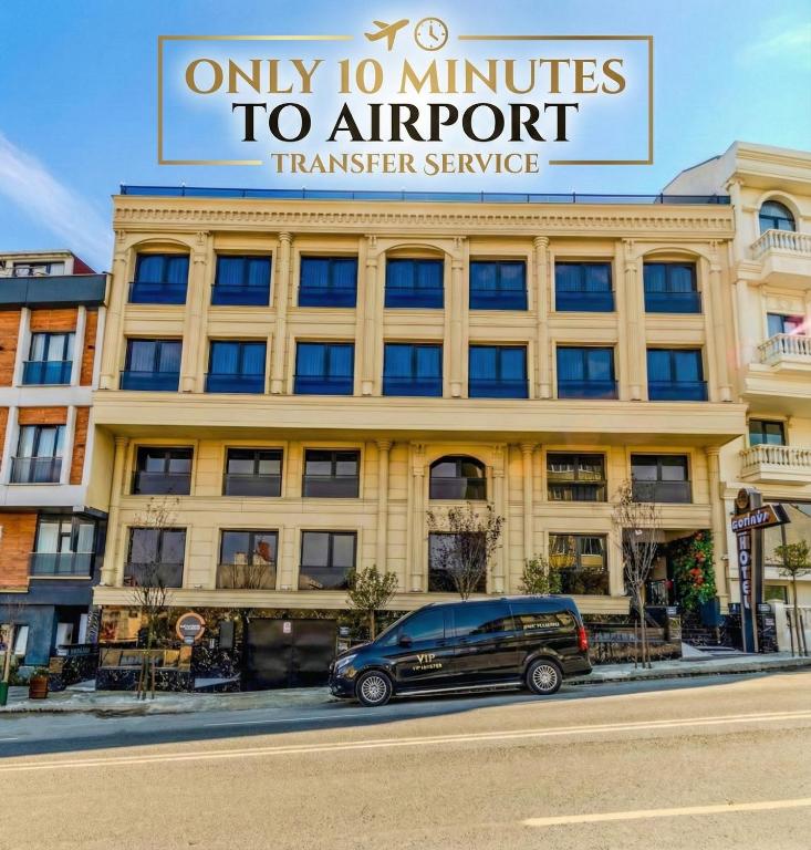 a van parked in front of a building at Cosinüs Airport Hotel in Arnavutköy