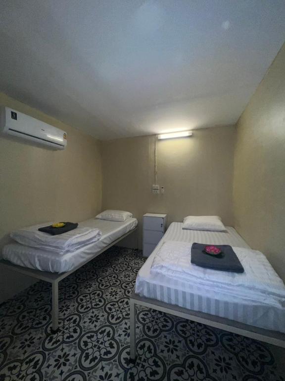 a small room with two beds in it at KiKi HOSTEL in Haad Rin