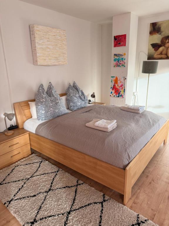a bedroom with a large bed with silver pillows at Waldblick Gästezimmer in Sonnenbühl