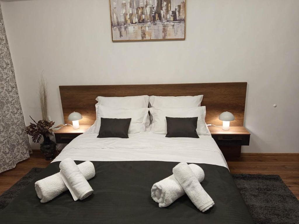 a bedroom with a large bed with towels on it at Studio Kath&Darc in Ruse