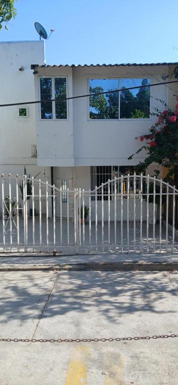 a white fence in front of a building at Casa La Fe in Cartagena de Indias