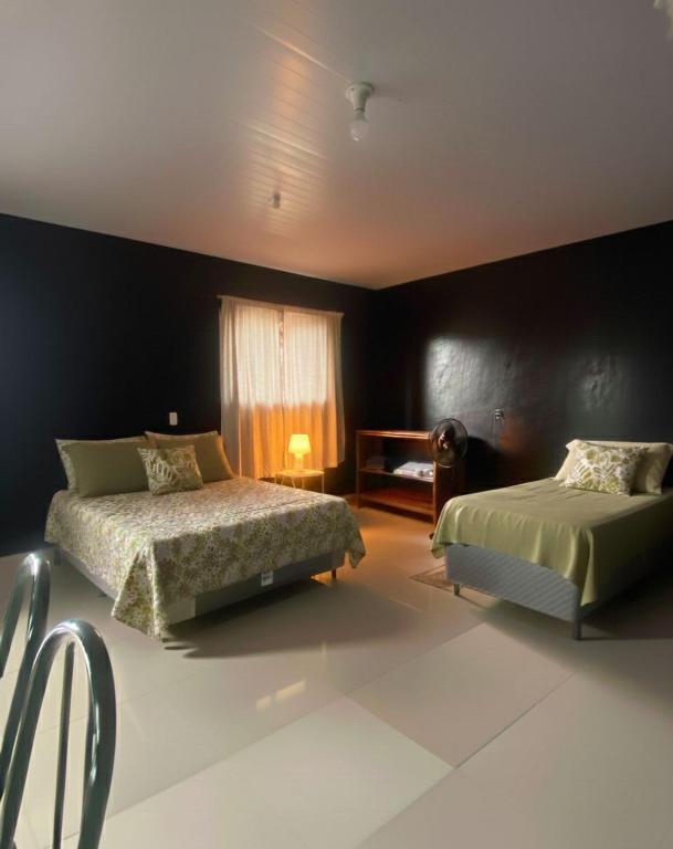 a bedroom with two beds and a window at Apartamento 02 completo Natal ZN próx norte shopping e praias in Natal