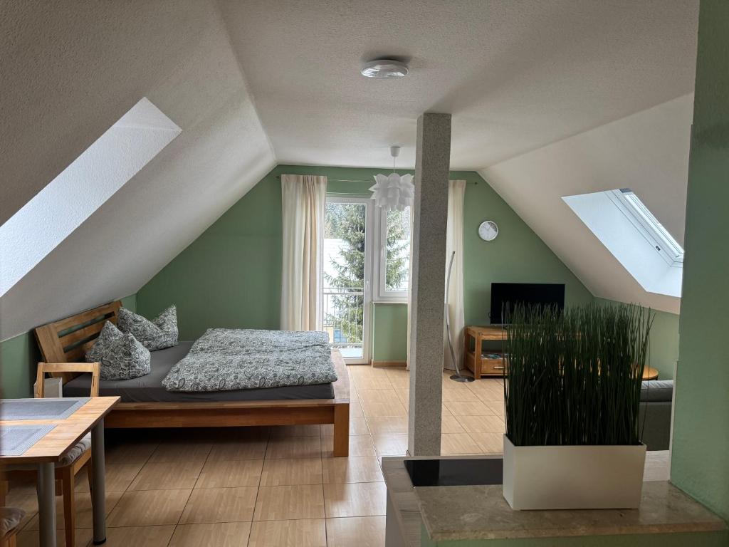 a bedroom with a bed in a room with green walls at Magdalena Apartment 2 in Elend