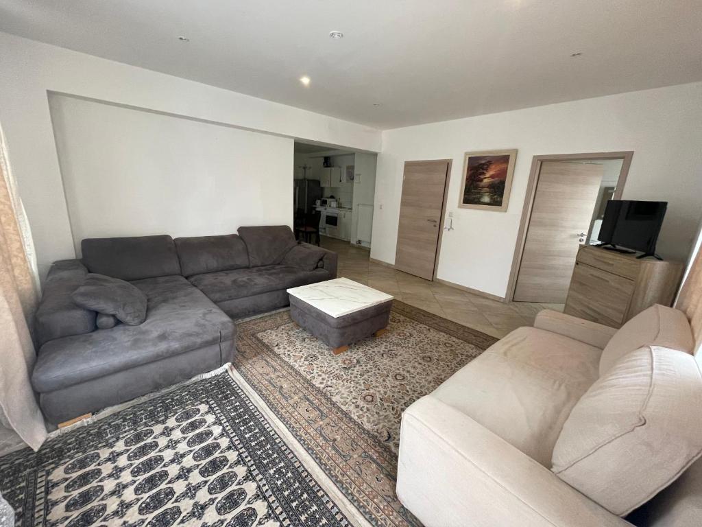 a living room with a couch and a table at City Lux Hannover in Hannover