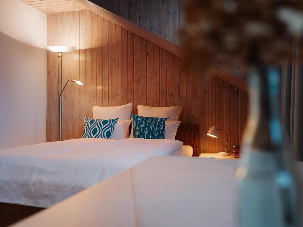 a bedroom with two beds with blue and white pillows at Chalet Flandesbach in Velbert