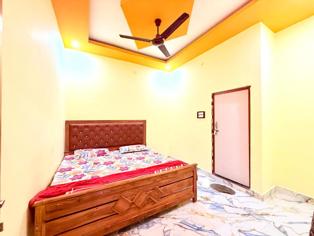 a bedroom with a bed and a ceiling fan at Hotel embrace in Bhauli