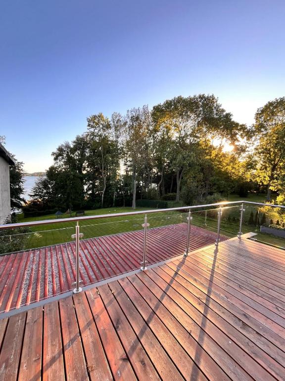 a metal railing on a deck with trees in the background at Seeidyll Potzlower See in Potzlow
