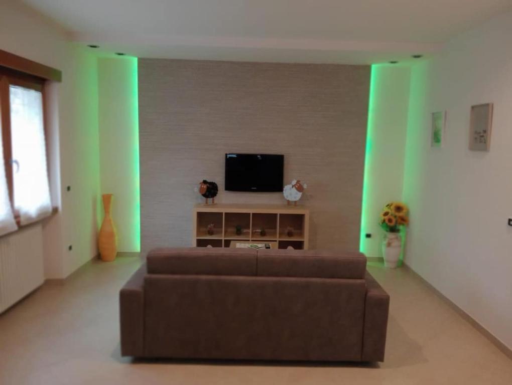 a living room with a couch and a flat screen tv at Casa Vacanze Giano in Antrodoco