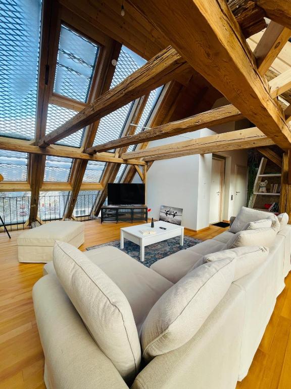 a large living room with a large white couch at Schwarzwald Mauer Loft in Bräunlingen