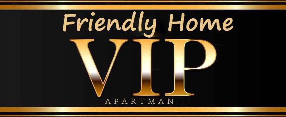 a black and gold sign with the words friendly home vip at VIP Apartman Friendly Home in Tuzla