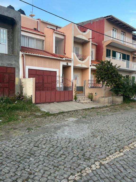 a group of buildings with a red garage at Home Lenda in Tarrafal