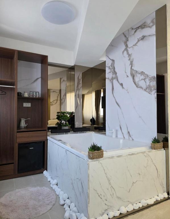 a large bathroom with a tub and a large mirror at PETKOV5KI LuxuryApartment in Skopje
