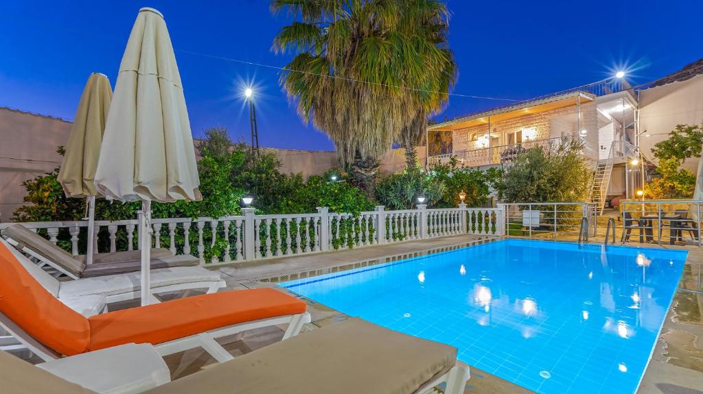 a swimming pool with an umbrella and chairs and an umbrella at Villa Neymar in Kaş