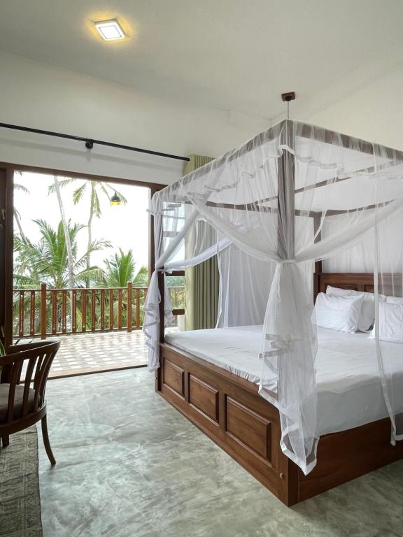 En eller flere senge i et værelse på Tangalle Bay Beach Villa