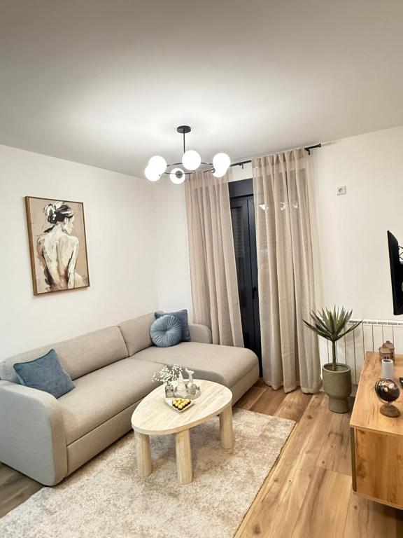 a living room with a couch and a table at CENTRAL SQUARE Tuzla in Tuzla