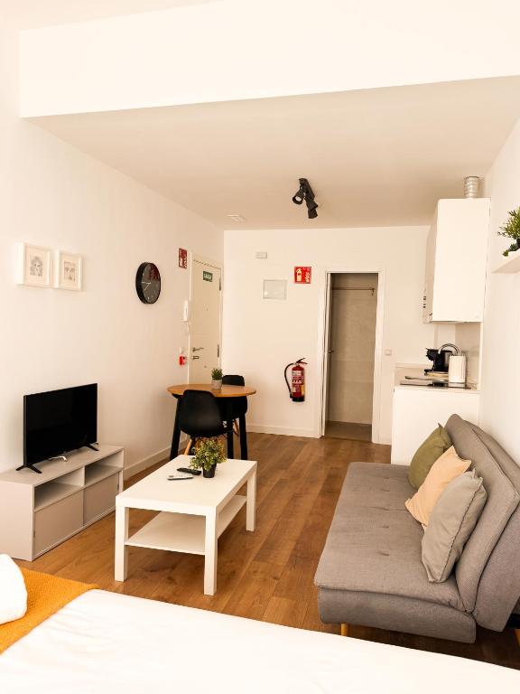 a living room with a couch and a table at Genesis-Loft San Enrique 20 in Madrid