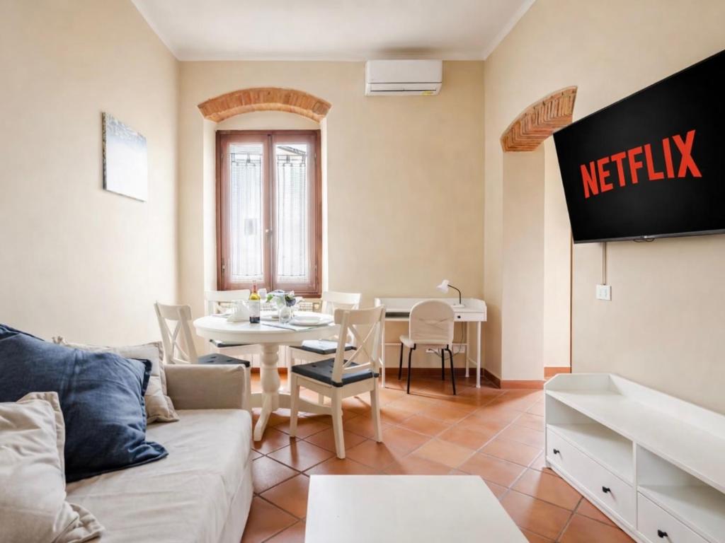 a living room with a couch and a table at Paradise Apartment, Comfort e Private Parking in Prato
