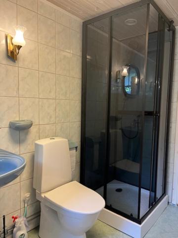 a bathroom with a toilet and a glass shower at Kungsskogen Kolmården in Kolmården