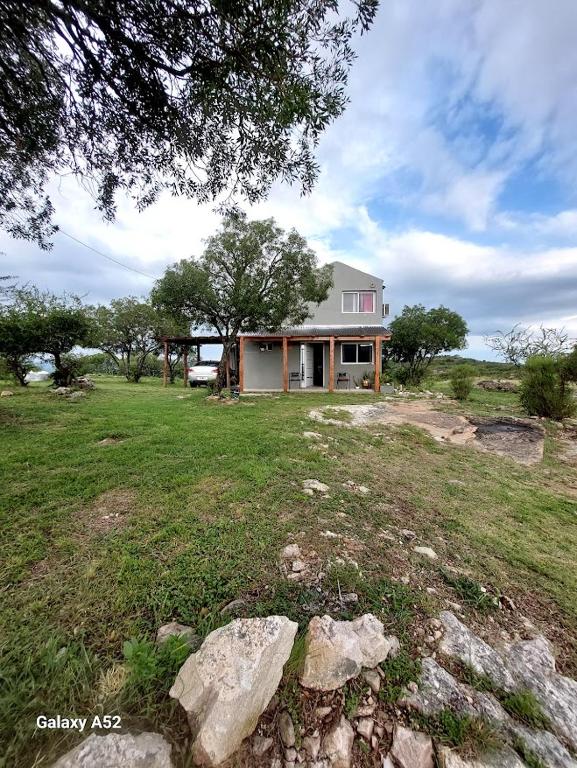 a house in the middle of a field at La Loma del Valle in Tanti
