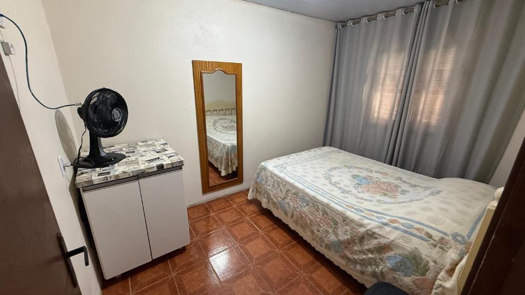 Giường trong phòng chung tại Casa praia Itapeva, Torres