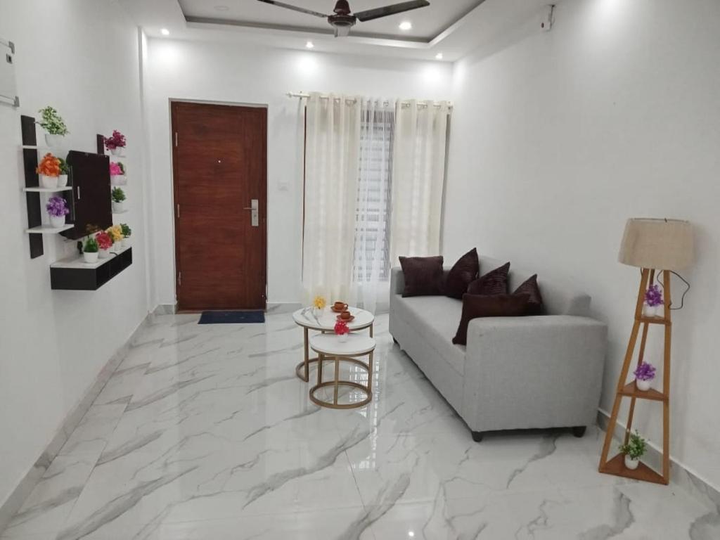 a living room with a couch and a table at EVA Residency in Kallar