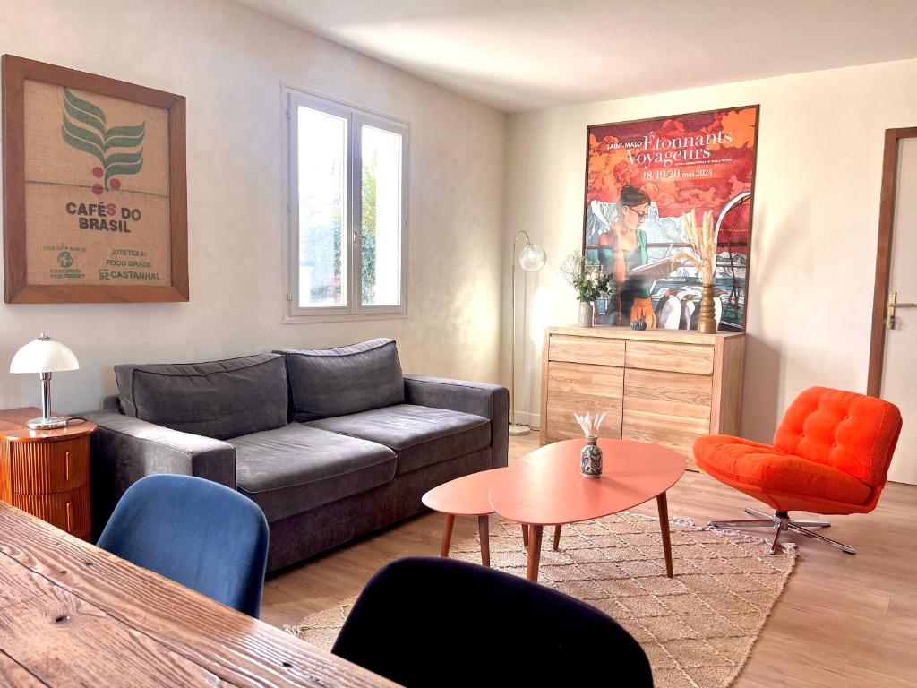 a living room with a couch and a table at Renovated house near beaches in Saint-Coulomb