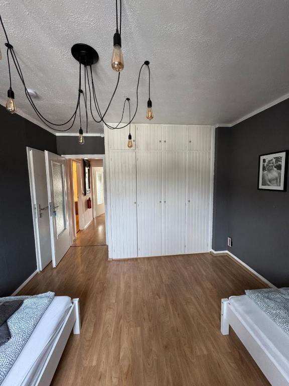 a large room with two beds and a closet at DoubleRoom in shared apartment 2nd floor in Linz am Rhein